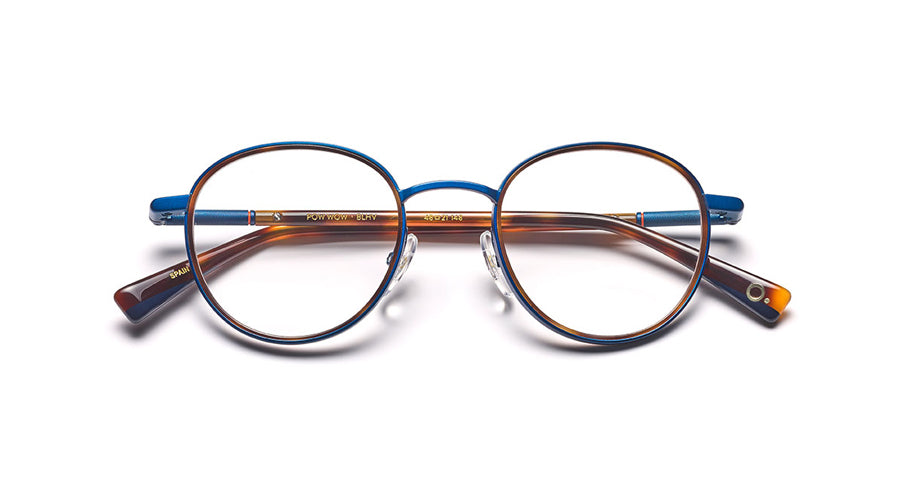 Men’s prescription eyewear: A front view of a round, blue metal frame with Havana temples. The Etnia insignia located on the inside of the temple tips.