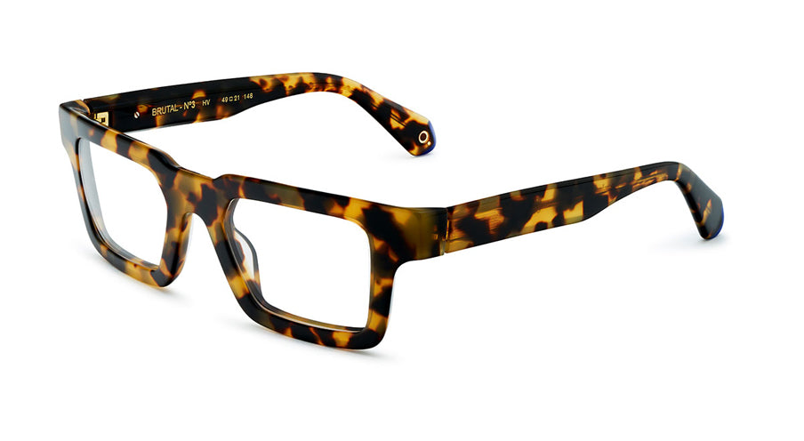 Unisex prescription eyewear: A side view of a bold tortoise square frame made of acetate. The Etnia insignia located on the inside of the temple tips.