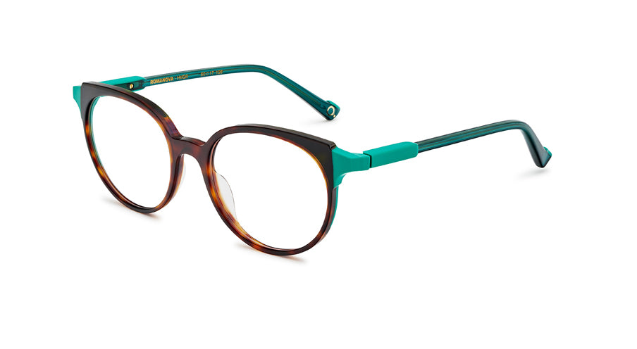 Women’s prescription eyewear: A side view of an oval tortoise front with clear turquoise temples. Part of the hinges are made of a solid plastic the same shade. The Etnia insignia located on the inside of the temple tips.