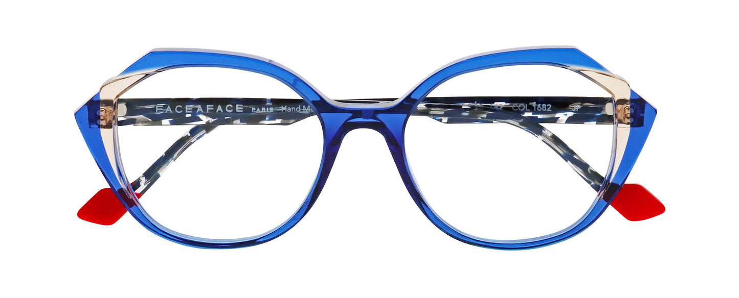 Women's prescription eyewear – A partial side view of an acetate frame that is geometric in shape and ultra blue/transparent in colour.  The blue and translucent speckled temples are finished with red tips. 