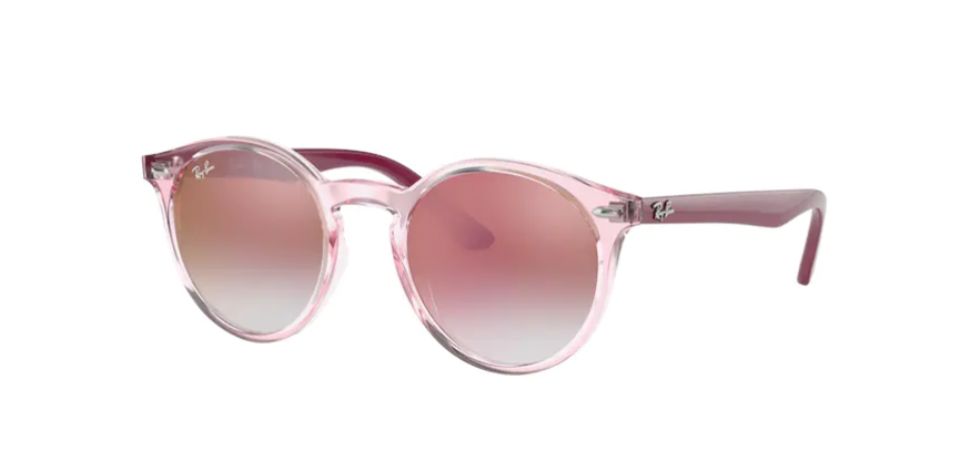Kid’s sunglasses: A side view of the RJ9064S model. The round frame is transparent pink with Bordeaux temples and red lenses. Ray-Ban logo is located by the hinges.