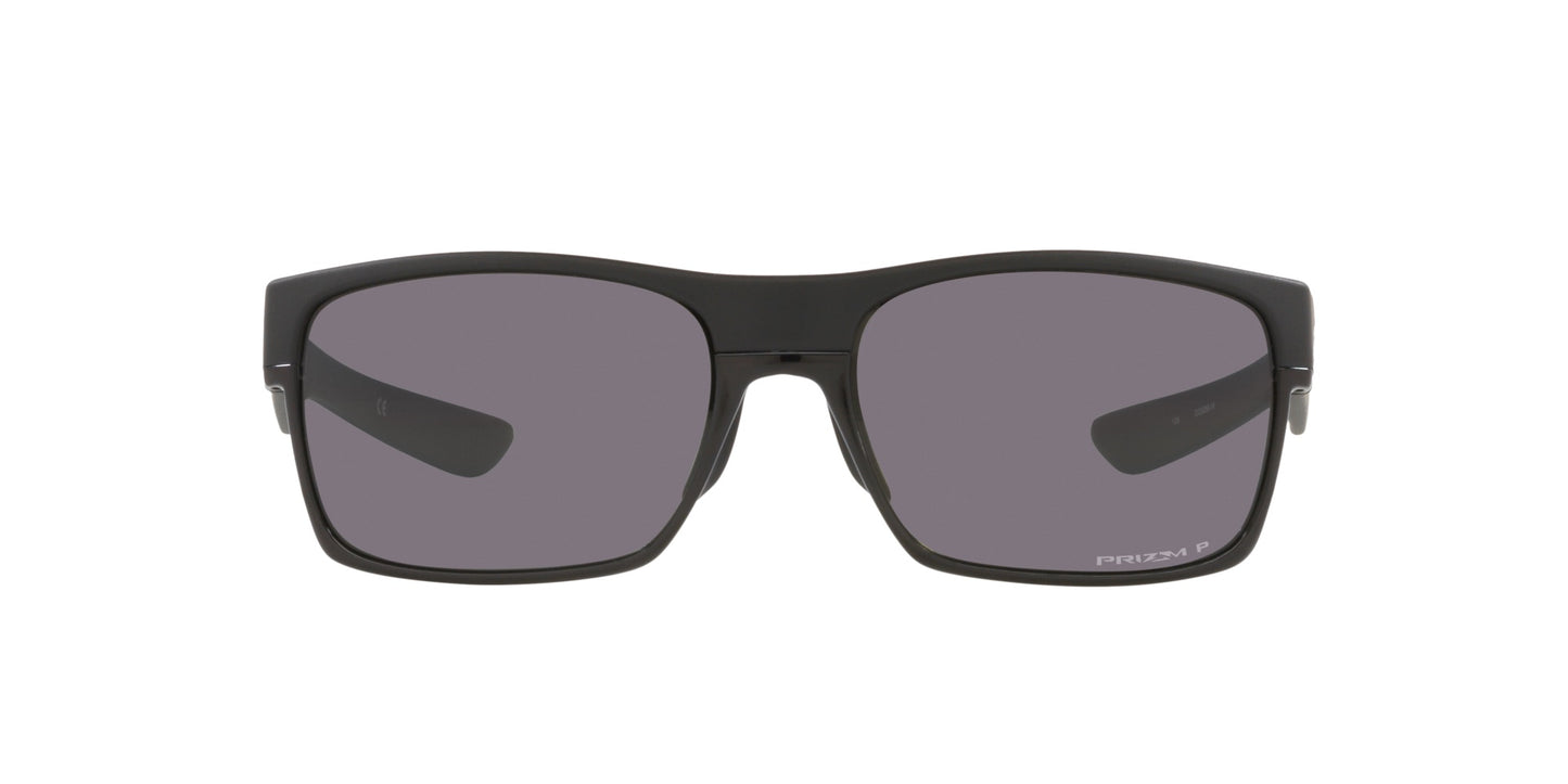Men’s sunglasses - A front view of the Two Face model:  A rectangular matt black frame made of Oakley's trademark O Matter lightweight material. The lenses are prism grey and polarized. 