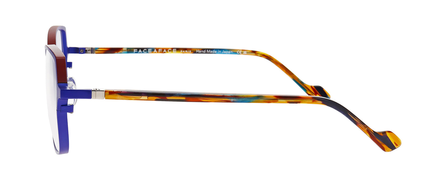 Women's prescription eyewear – A side view of a titanium frame that is in a cat-eye shape and matt purple colour. The temples are made with acetate and in a mix of translucent blue/red/gold colours.